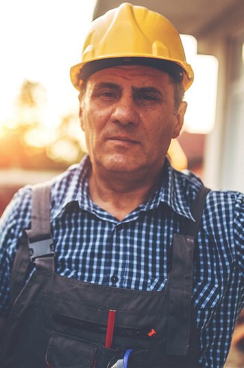 middle aged man wearing a yellow hard hat