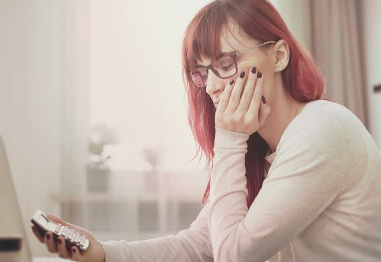 woman with calculator trying to understand workers' comp pay in Minnesota